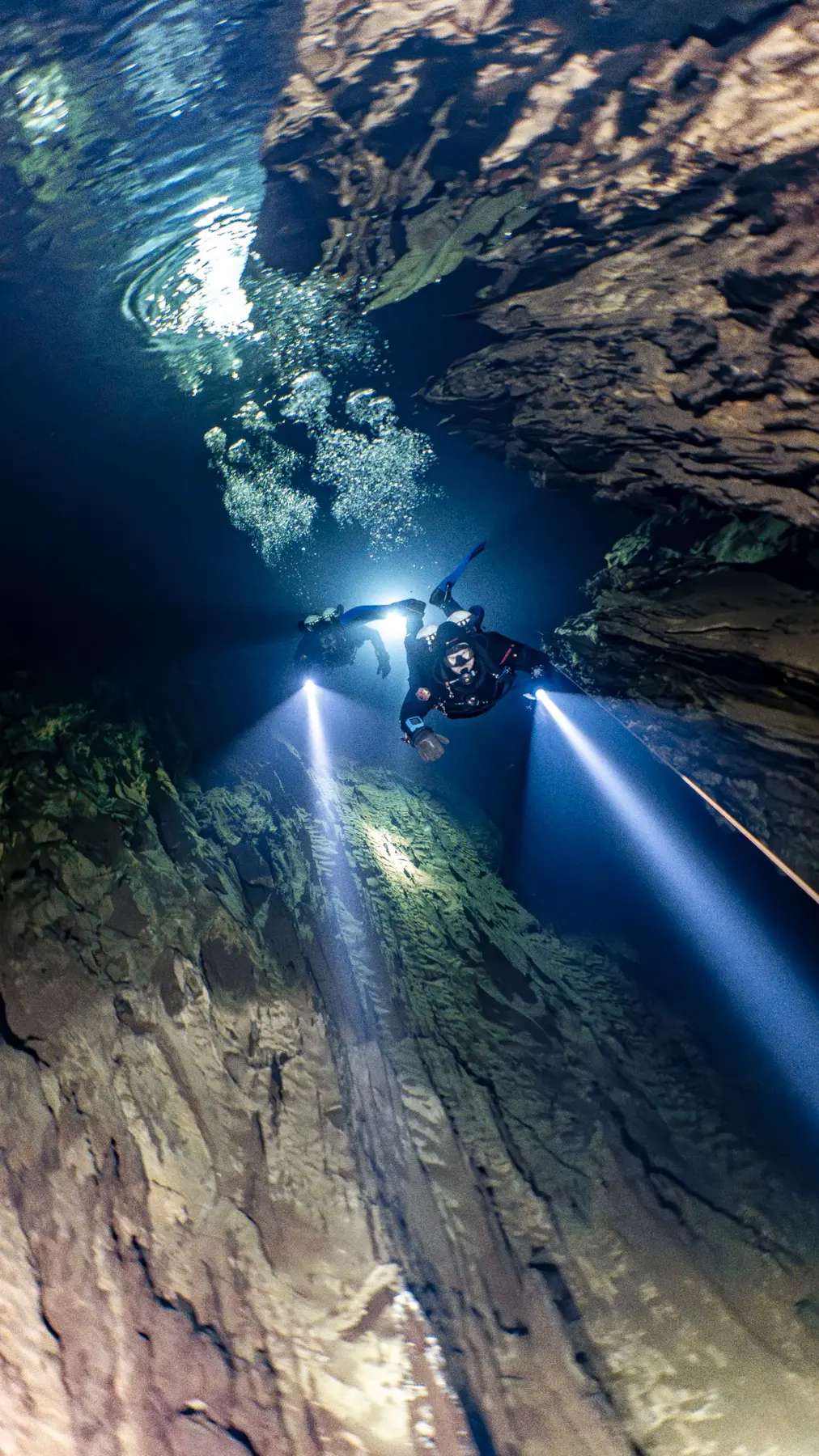 Cave diver moving through a submerged passage
